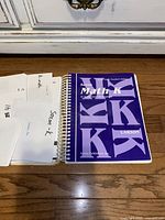 Photo showing the Saxon Math K Home Study Teacher's Edition spiral-bound workbook with multiple loose papers beside it.