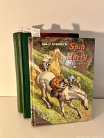 Front view of three vintage hardcover children's books with Western and adventure themes. Disney's Spin and Marty book has illustrated cover with characters on horses.