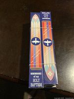 Four boxed baptismal candles placed together showing the front design featuring stained glass styling and the text 'REMEMBRANCE of my HOLY BAPTISM' with dove symbols.