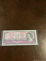 Front side of the 1954 Canadian $10 banknote showing Queen Elizabeth II portrait and serial numbers.