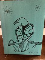 Full frontal view of Canadian Indigenous Art painting depicting an eagle with stylized wings perched on a branch, signature visible bottom right.