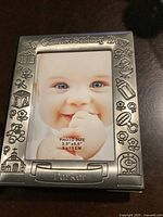Photo of silver-tone metal Christening-themed photo frame with space for 3.5x5 inch photo.