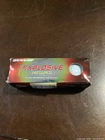 Front view of one Dunlop Explosive Distance Ignited golf ball box, new condition.