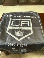 Black fabric pennant showing full design with logo, text, and years 2012 and 2014.