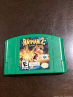 Front view of green Nintendo 64 cartridge with Rayman 2: The Great Escape label.