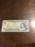 Front of the 1973 Canadian one-dollar bill showing Queen Elizabeth II portrait and denomination.
