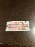 Front side of the 1986 Canadian two dollar banknote showing Queen Elizabeth II and denomination details.