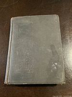 Front hardcover of the vintage book Lorna Doone showing worn dark green cloth cover with embossed design.