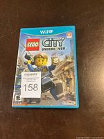 Front cover of Wii U game case for Lego City Undercover showing Lego character artwork and branding.