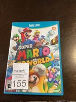 Front cover of Wii U game Super Mario 3D World in blue plastic case, showing colorful Mario characters.