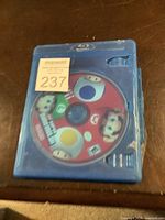 Front view of Nintendo Wii Super Mario Bros. game disc in blue case showing character artwork and ESRB rating.