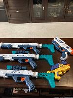 Group photo of all 5 foam dart blaster guns on table