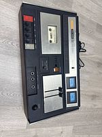 Top view of Akai CS-33D cassette player showing control buttons, cassette compartment, and input jacks.