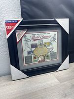 Framed 'Take Me Out to the Ball Game' baseball postage stamps artwork with protective corner covers and price tag of $39.99 retail.
