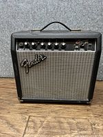 Closed front view of Fender Frontman 15G amplifier showing control panel and Fender logo.