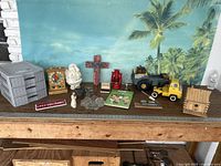 Full view of all toy and decor items arranged on table with tropical backdrop, showing variety and size of pieces.