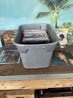 Grey tote filled with a collection of LP records, displayed with several album covers (Van Seals, Peaches & Herb, Burton Cummings) around it.