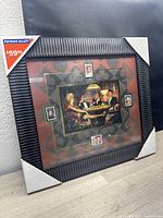 Front view of the framed postal artwork in original packaging with Postmark Gallery price sticker showing $59.99.