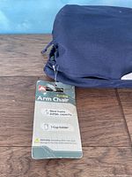 Photo of chair's product tag showing features: steel frame, 225 lb capacity, 1 cupholder.