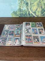 Open binder showing two pages of baseball cards; cards include Houston Astros players, among others; all pockets filled with cards; cards are varied in design and year.