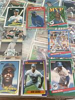 Close-up image of assorted baseball cards featuring Ken Griffey Jr. and Gene Harris among others, showing variety in card front designs and colors.