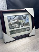Framed U.S. Army photograph and coin set with protective corner covers.