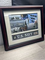 Framed US Navy art showing Navy vessels, jets, personnel, and the "U.S. NAVY" label.