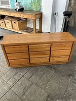 Full view of vintage oak dresser showing nine drawers and overall structure