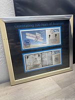 Front view of the framed and matted 2003 Wright Brothers first day covers celebrating 100 years of aviation. Shows the artwork, stamps, and matting.