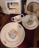 Plate, bowl and cup with Peter Rabbit designs displayed together