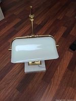 Front view lamp showing shade, brass arm, marble base