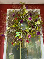 Front view of twig wreath with assorted flowers on door