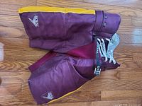 Front view of maroon and yellow Royal hockey pants