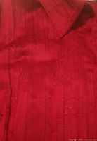 Close-up of fabric, embroidery and pintuck detail