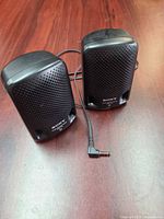 Front view of the two black Sony mini speakers with right-angle 3.5 mm plug visible