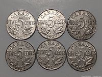 Six Canadian 5 cent coins dated 1927, reverse side showing denomination and maple leaves.