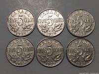 Six Canadian 5 cent coins from 1928, reverse side showing denomination and maple leaf design