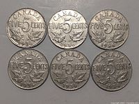 Reverse view of six Canadian five-cent coins dated 1936 showing ACANADA FIVE 5 CENTS 1936 engraving with maple leaves.