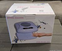 Box showing the nail drying machine image and branding, indicating new condition.
