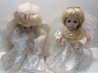 Both angel figurines side by side showing their full bodies, wings, and dresses.