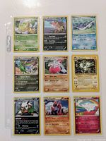 Photo of all nine Pokemon cards arranged in a 3x3 grid showing front artwork and text details of each card.
