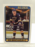 Front photo of 1989-90 O-Pee-Chee Rod Brind'Amour rookie hockey card, showing player in St. Louis Blues jersey.