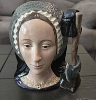 Close-up of Anne Boleyn sculpted face and detailed headdress on the Toby Jug, showing quality and condition of the ceramic and paint.