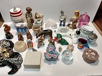 Top-view photo showing the full group of small decorative items including figurines, mask, ceramic and glass items.