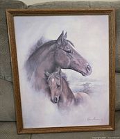 Full view of framed horse print showing adult horse and foal with faint running horses in background.