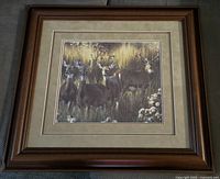 Wood framed print showing a group of five deer in natural setting, surrounded by beige matting and wood-colored frame.