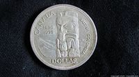 Obverse of the 1958 Canadian Silver Dollar featuring totem pole and commemorative text