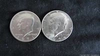 Obverse side showing John F. Kennedy's profile on the 1971 and 1974 half dollars, with years clearly visible.