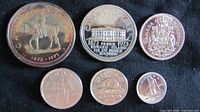 Top side view of six 1973 Canadian coins showing detailed front designs, including Prince Edward Island commemorative dollar, RCMP dollar, and others