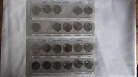 Two plastic holders with Canadian 1999 Millennium quarters arranged by month, complete set and incomplete set.